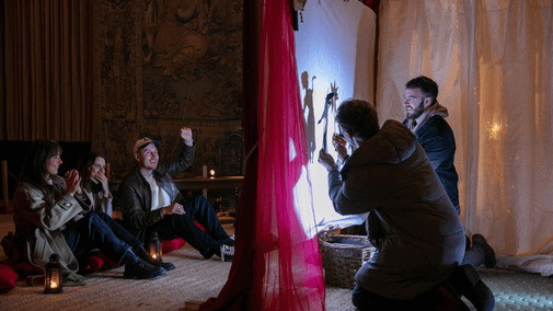 Visitors playing with shadow puppets at Hardwick, Derbyshire